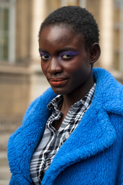 A model wears purple eyeshadow and red lipstick on February 29, 2020 in Paris, France. (Photo by Kir...