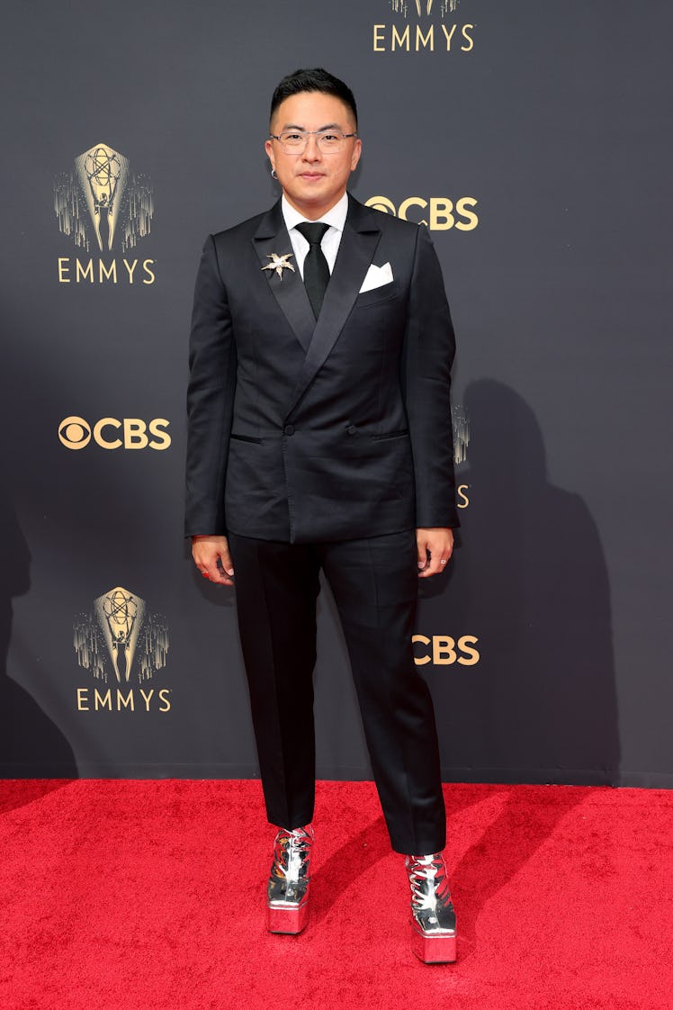 Bowen Yang in a black suit, a white shirt and a black tie at the Emmys Red Carpet 2021