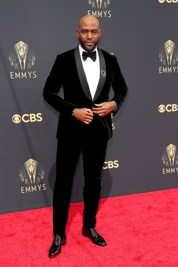 Karamo Brown in a black suit, a white shirt and a black bow tie at the Emmys Red Carpet 2021