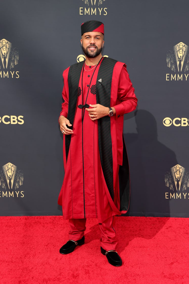 O-T Fagbenle in a red-black shirt-waistcoat and trousers and hat at the Emmys Red Carpet 2021