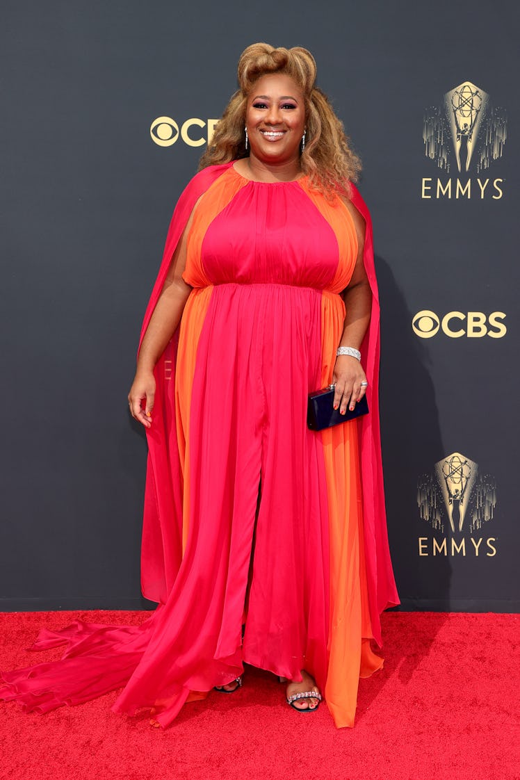 Ashley Nicole Black in a pink-orange dress at the Emmys Red Carpet 2021