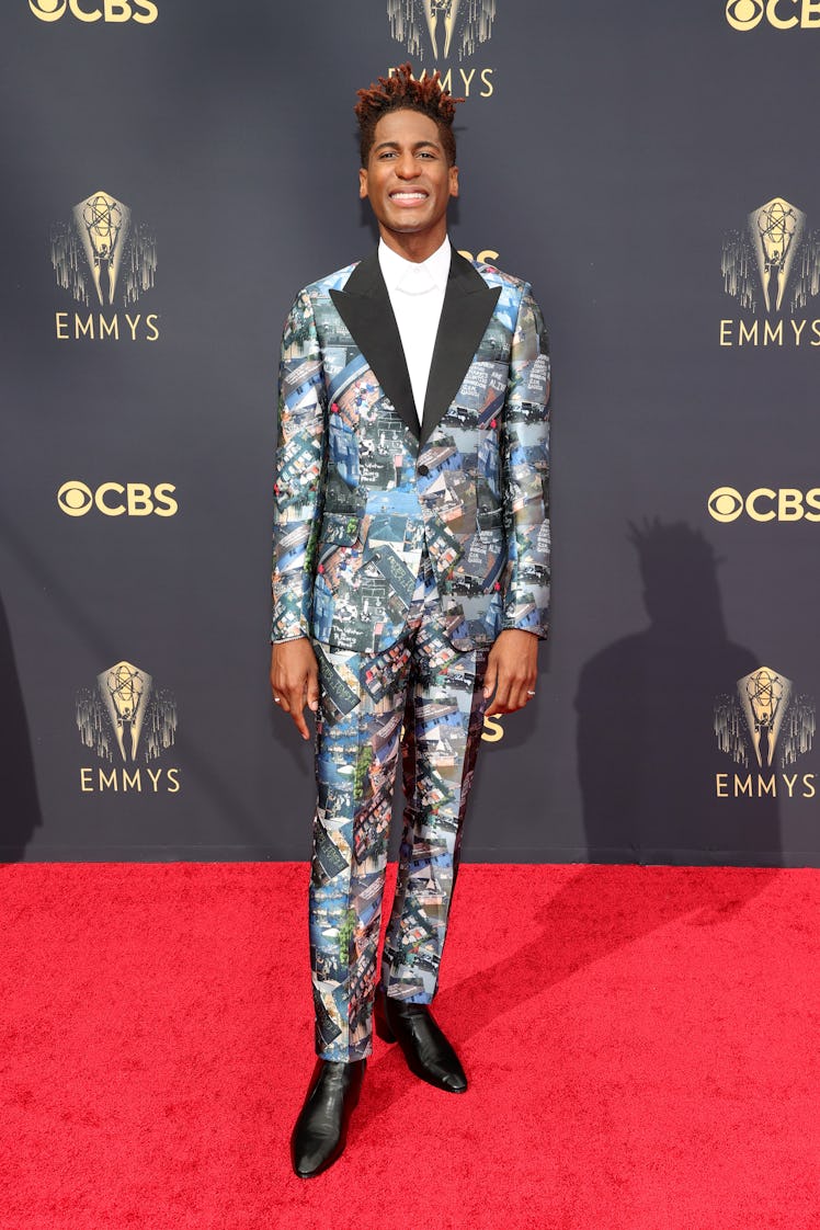 Jon Batiste in a multi-colored suit and a white turtleneck at the Emmys Red Carpet 2021