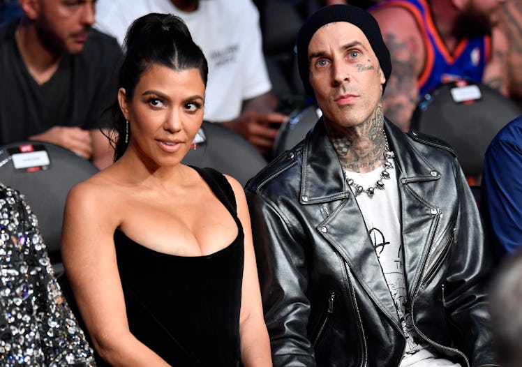 Kourtney Kardashian and Travis Barker attend the UFC 264 event in July of 2021, just before vacation...