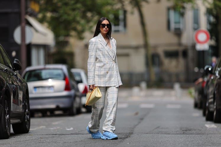 A fashion influencer demonstrates how to wear sneakers in a business casual environment