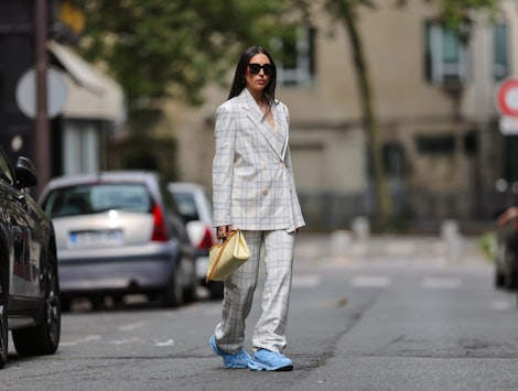 A fashion influencer demonstrates how to wear sneakers in a business casual environment