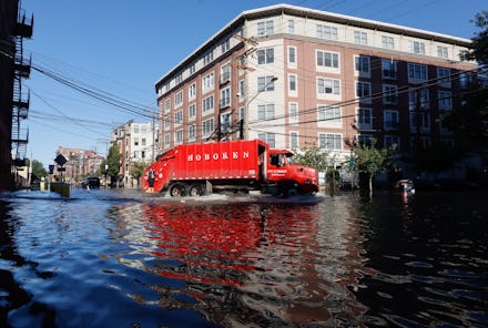 HOBOKEN, NJ - SEPTEMBER 2: A sanitation truck drives through a flooded street the morning after the ...