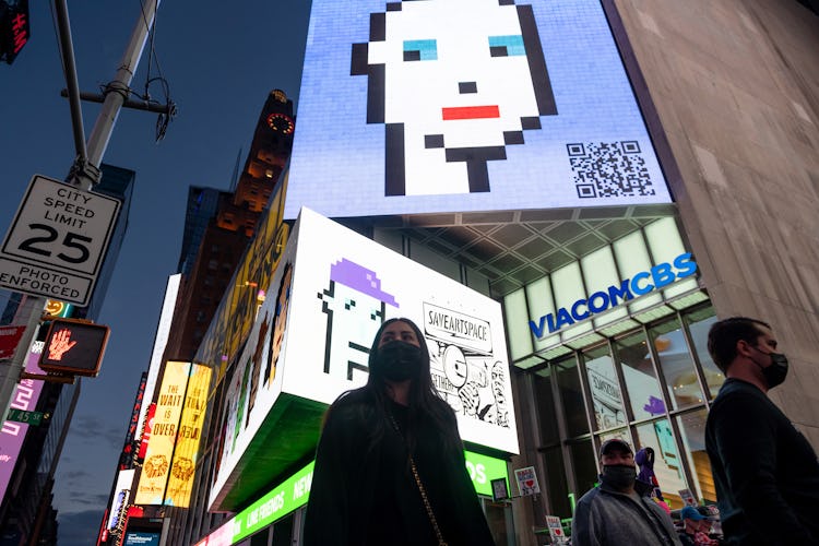 NEW YORK, NEW YORK - MAY 12: People walk past CryptoPunk digital art non-fungible token (NFT) displa...