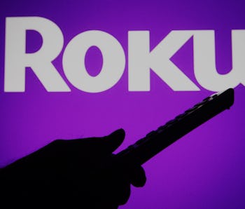 UKRAINE - 2021/07/04: In this photo illustration a Roku logo is seen on a screen with a silhouette o...