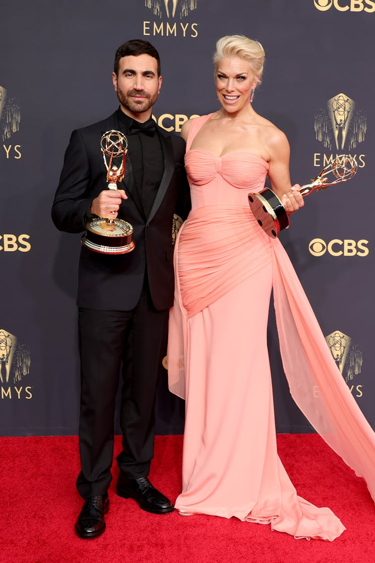 Brett Goldstein in a black suit and Hannah Waddingham in a peach dress at the Emmys Red Carpet 2021