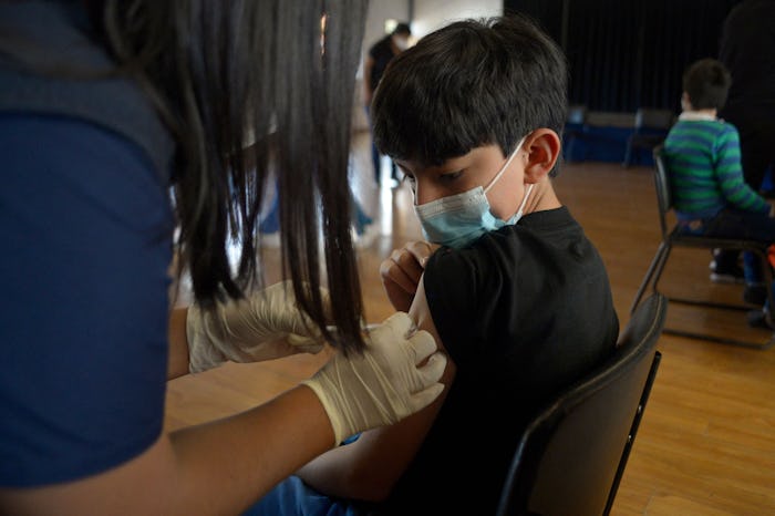 A boy receives the first dose of the Pfizer/BioNTech COVID-19 vaccine at a private school in Quito o...