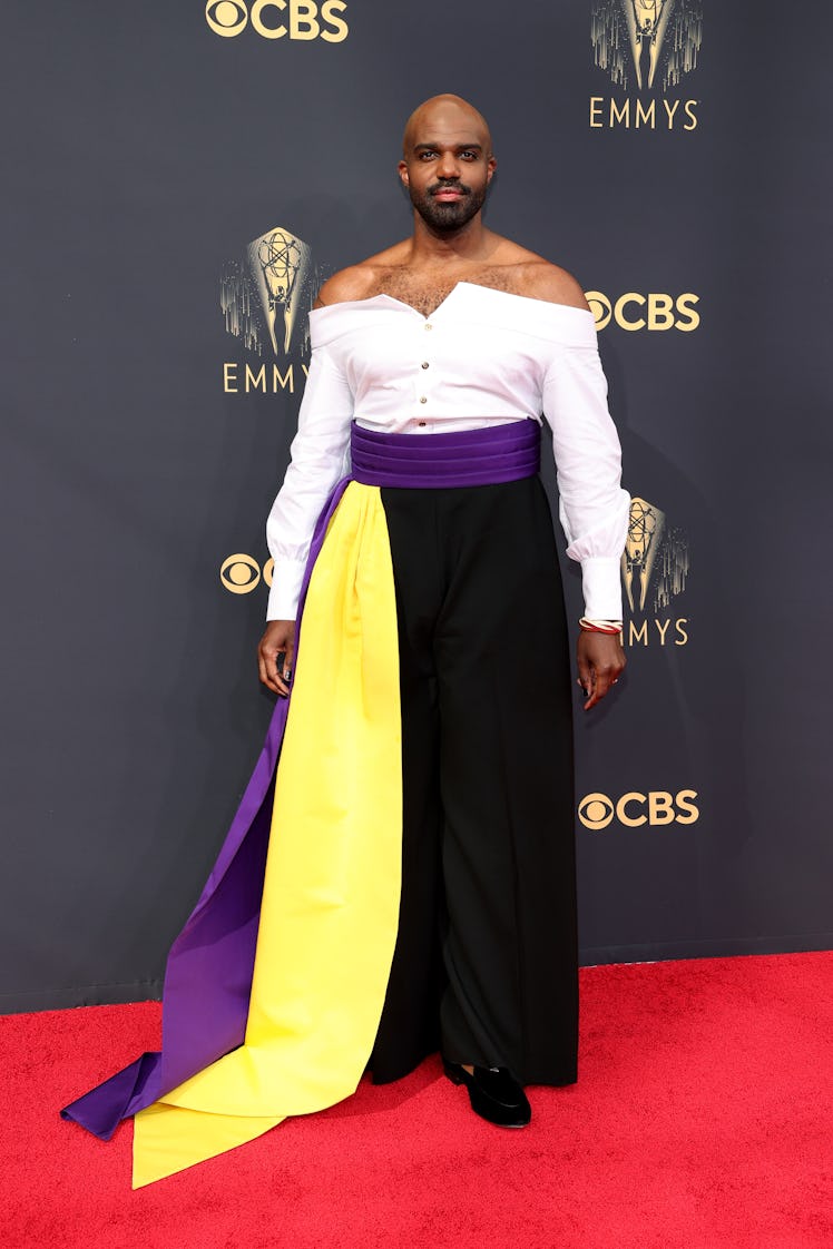 Carl Clemons-Hopkins in a white blouse and black-purple-yellow trousers at the Emmys Red Carpet 2021