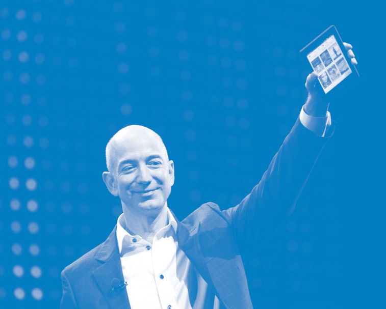 SANTA MONICA, CA - SEPTEMBER 6: Amazon CEO Jeff Bezos holds a new front-lit Kindle Paperwhite 3G re...