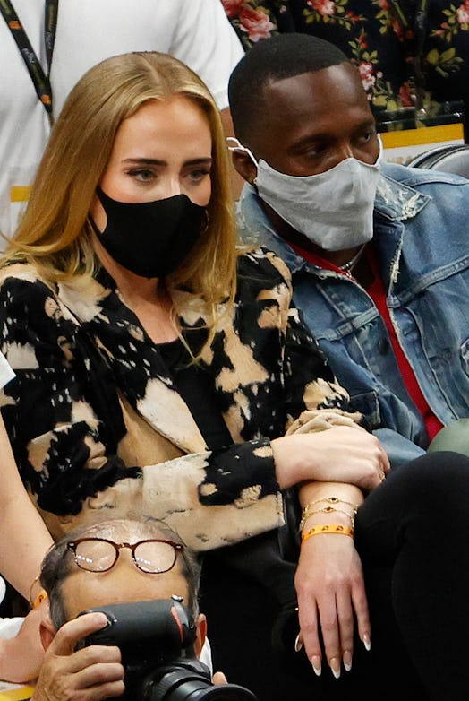 PHOENIX, ARIZONA - JULY 17: Singer Adele looks on next to Rich Paul during the first half in Game Fi...