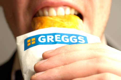 A man enjoying his recently purchased Greggs sausage roll.. (Photo by: Newscast/Universal Images Gro...