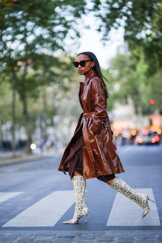 Tall animal print boots with a leather trench coat. 