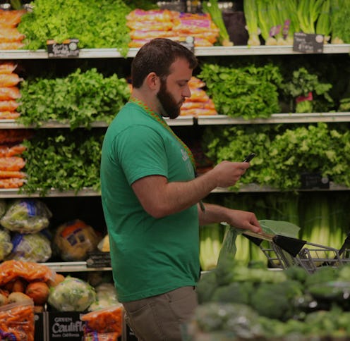 BOSTON, MA - MAY 28: Owen Amsler, an Instacart shift captain, shops for a customer in the Whole Food...