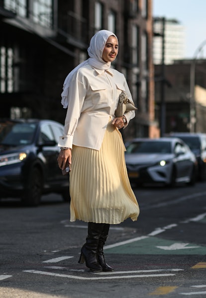 Tall boots worn with a midi skirt. 