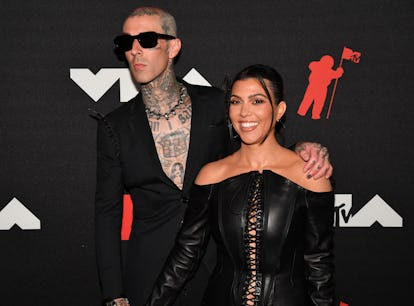 Kourtney Kardashian and Travis Barker's matching name necklaces are proof that PDA can be wholesome.