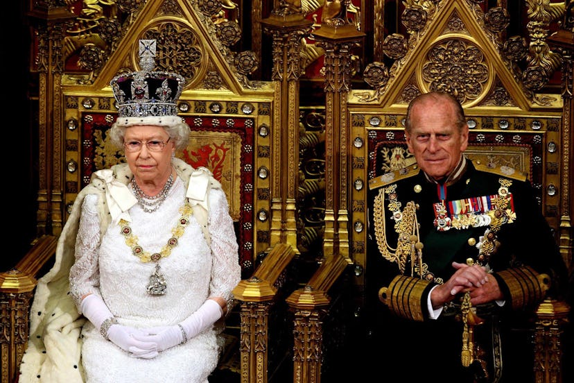 Britain's Queen Elizabeth II (L) sits next to the Duke of Edinburgh at the House of Lords, in Westmi...
