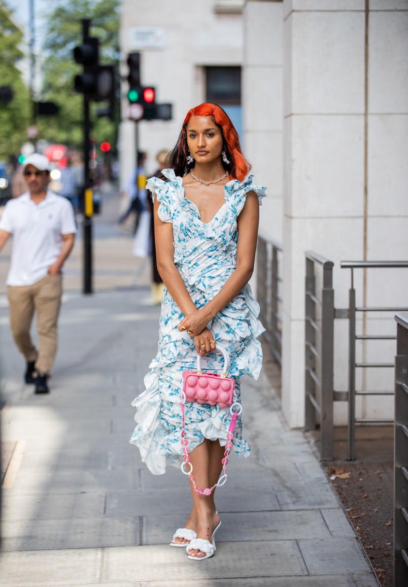 LONDON, ENGLAND - SEPTEMBER 18: A guest is seen wearing blue dress, pink bag outside yuhan wang duri...
