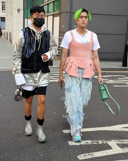 LONDON, ENGLAND - SEPTEMBER 18: Guest wearing frilled denim jeans, silver boots attends yuhan wang a...