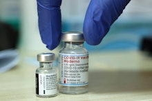 A medic places two vials of COVID-19 coronavirus vaccines (L to R): Pfizer-BioNTech and Moderna, on ...