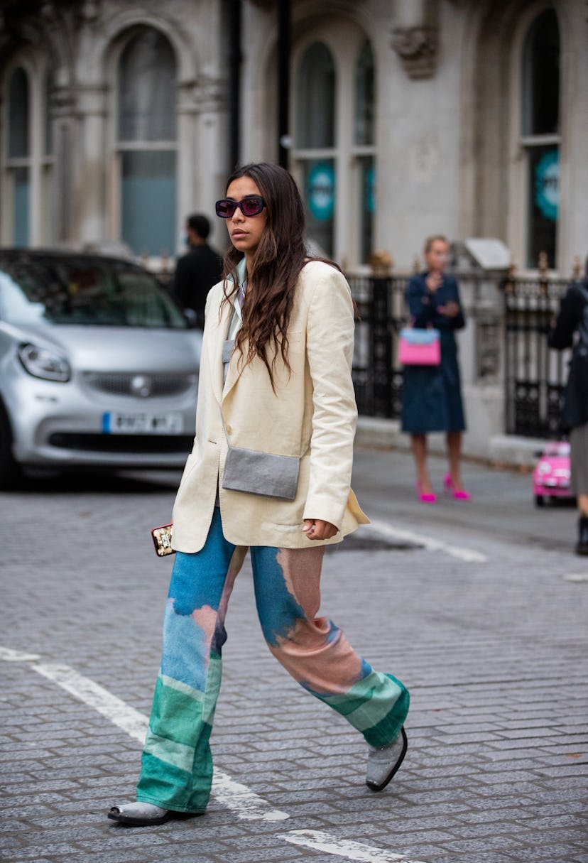 LONDON, ENGLAND - SEPTEMBER 19: A guest is seen wearing blazer, colorful pants outside ERDEM during ...