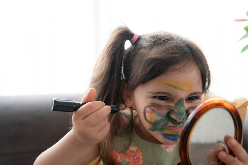 little girl painting her face.Painting - Activity, Smiling, Drawing - Activity, Child, Paint