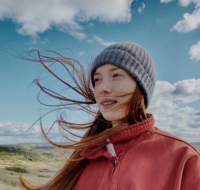Young woman looking out in the distance as she thinks about the major US city her zodiac sign matche...