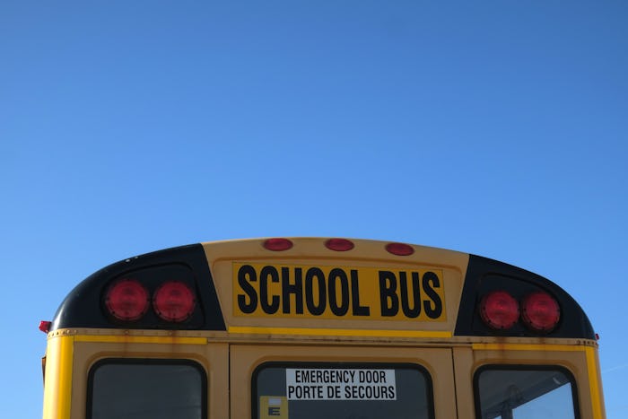 Text on the top of the back of a school bus.