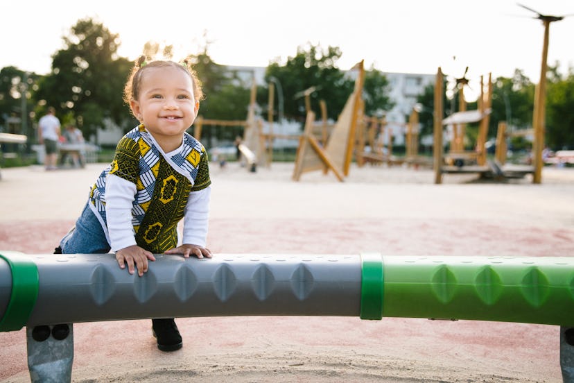 Carefree toddler playing on a playground