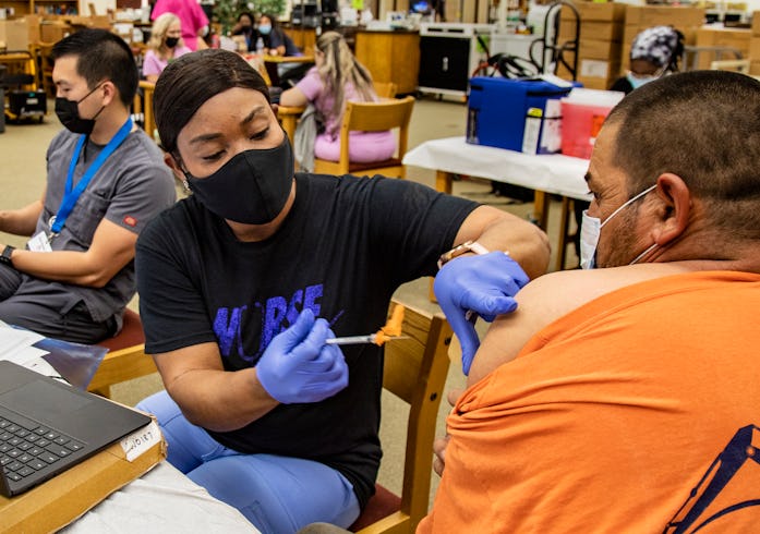 RIVERSIDE, CA - SEPTEMBER 22, 2021: Nurse Francemene Henry administers the Pfizer vaccine to Augusti...