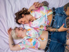 Directly above photo of a young lesbian couple. They are lying on the picnic blanket