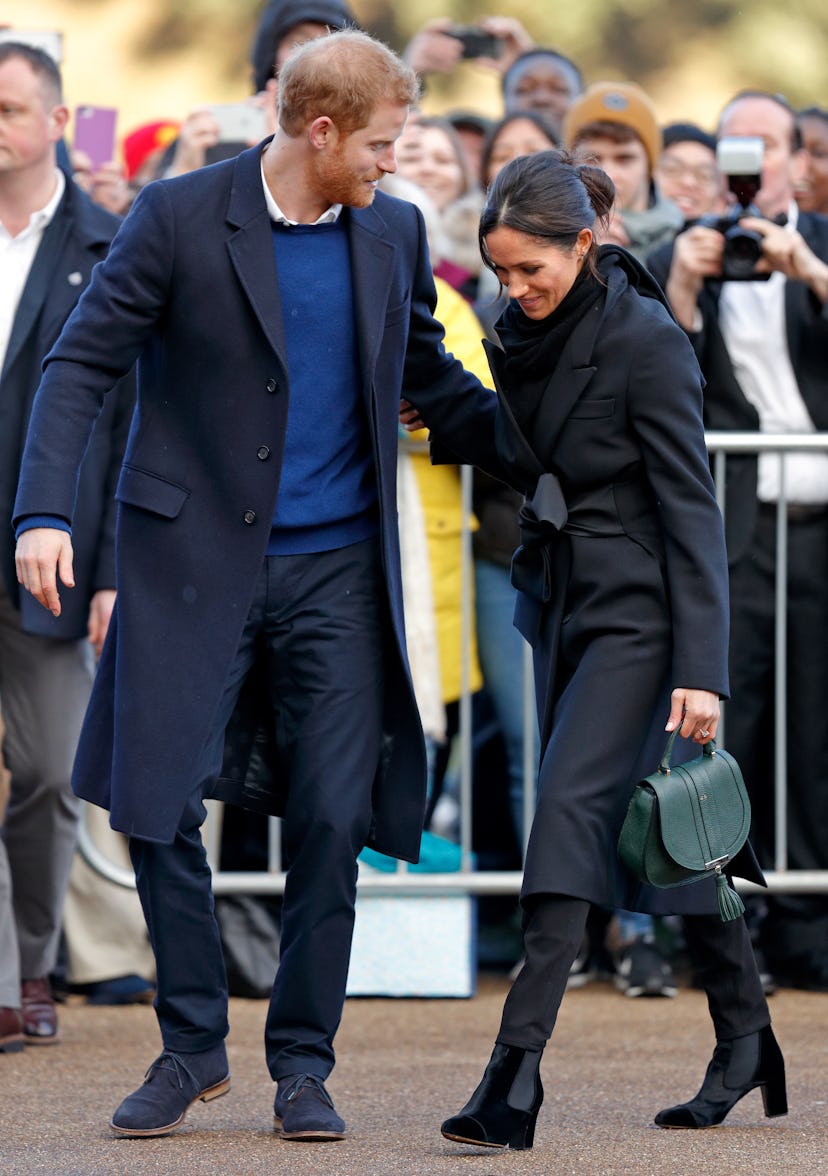 Meghan Markle wraps up in coat and boots.