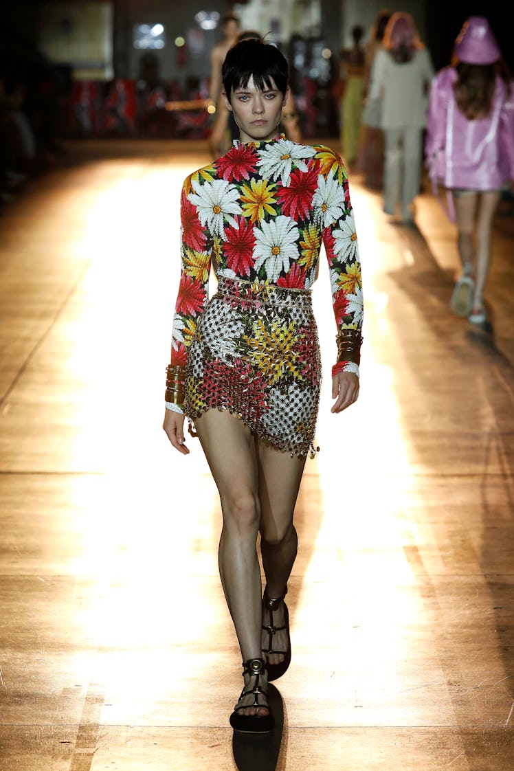 A model at the Etro fashion show at Milan Fashion Week Spring 2022 in a red, white and yellow floral...
