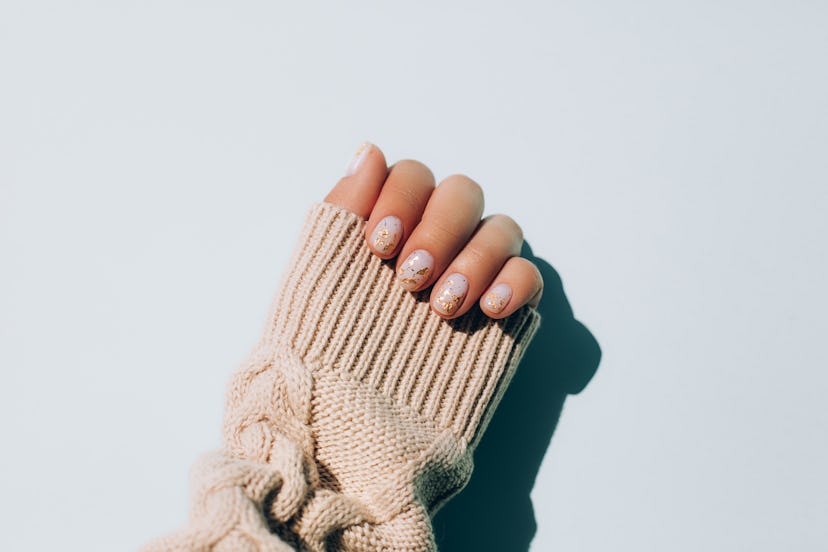 A woman shows off her brittle nails, one reason you might be craving red meat.