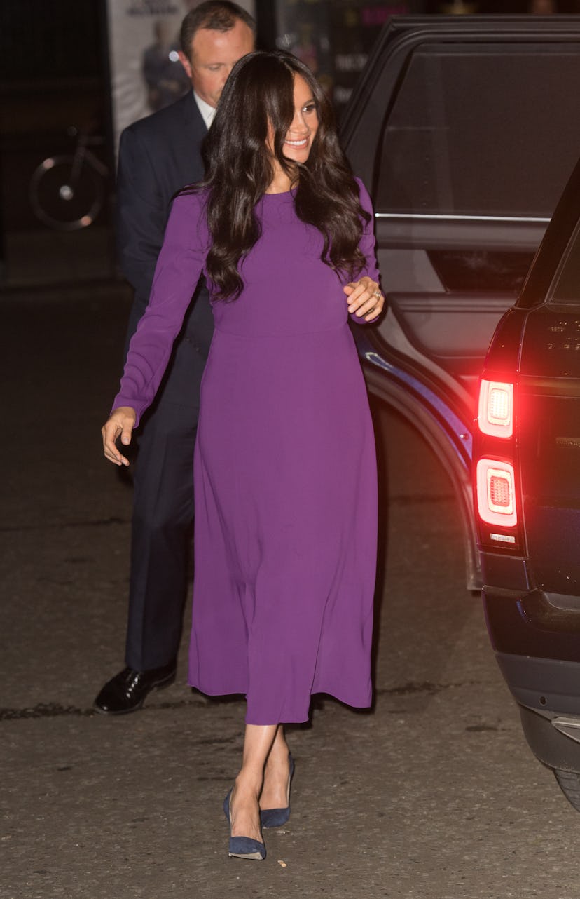 Meghan Markle in a purple dress.