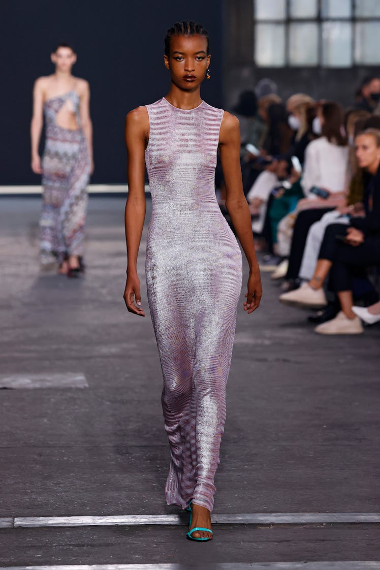 A model on the runway during the Missoni fashion show in a skin-tight light, floor-length sleeveless...