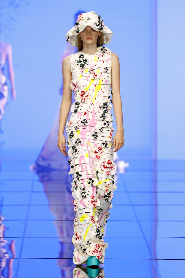 A model on the runway at the Del Core fashion show at Milan Fashion Week Spring 2022 in a floral dre...