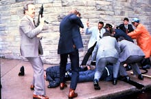 View of armed Secret Service agents around the bodies of policeman Thomas K Delahanty and White Hous...