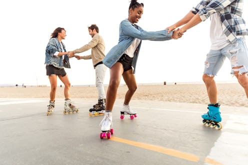 Friends roller skating on the boardwalk in Venice Beach. These are the most open-minded zodiac signs...