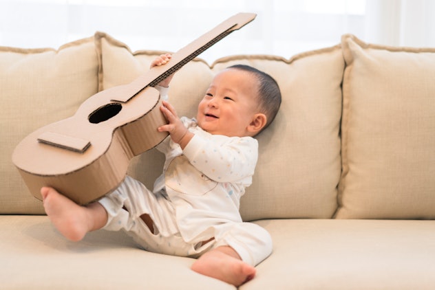 Baby boy playing with guitar