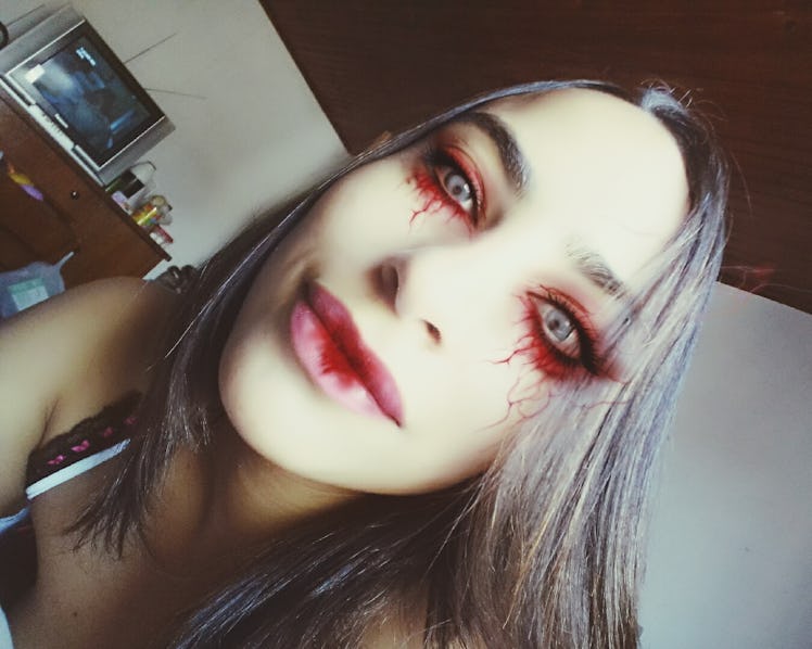 A woman with a red Halloween eye makeup look