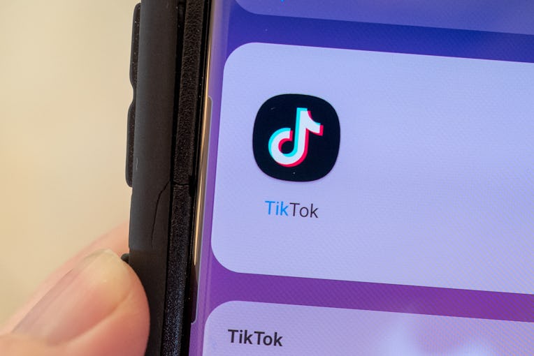 Close-up of human hand holding a cellphone displaying icon for the TikTok video sharing app, Lafayet...