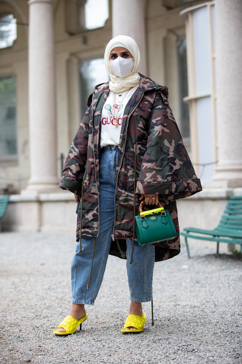 MILAN, ITALY - SEPTEMBER 25: Fatma Helal outside Salvatore Ferragamo fashion show wearing a camoufla...