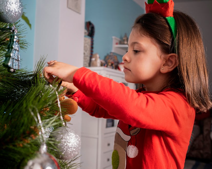 profile view of girl decorating Christmas tree