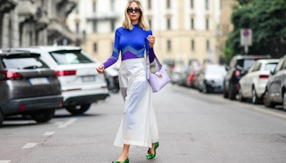 MILAN, ITALY - SEPTEMBER 25: Candela Novembre wears black sunglasses, a royal blue electric with pur...