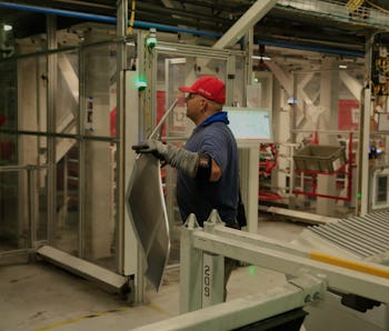 A production associate works in the body line for the Tesla Model 3 at the Tesla factory on Wednesda...