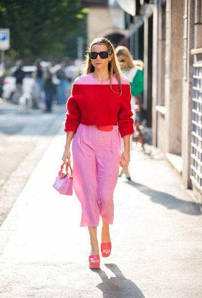 MILAN, ITALY - SEPTEMBER 22: Julia Comil seen wearing pink dress, red wool jumper, bag outside Alber...
