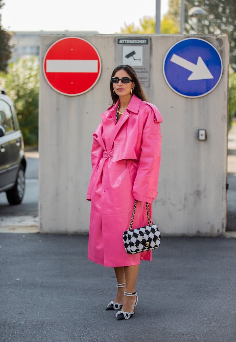 MILAN, ITALY - SEPTEMBER 24: Bettina Looney seen wearing pink oversized coat, checkered black white ...